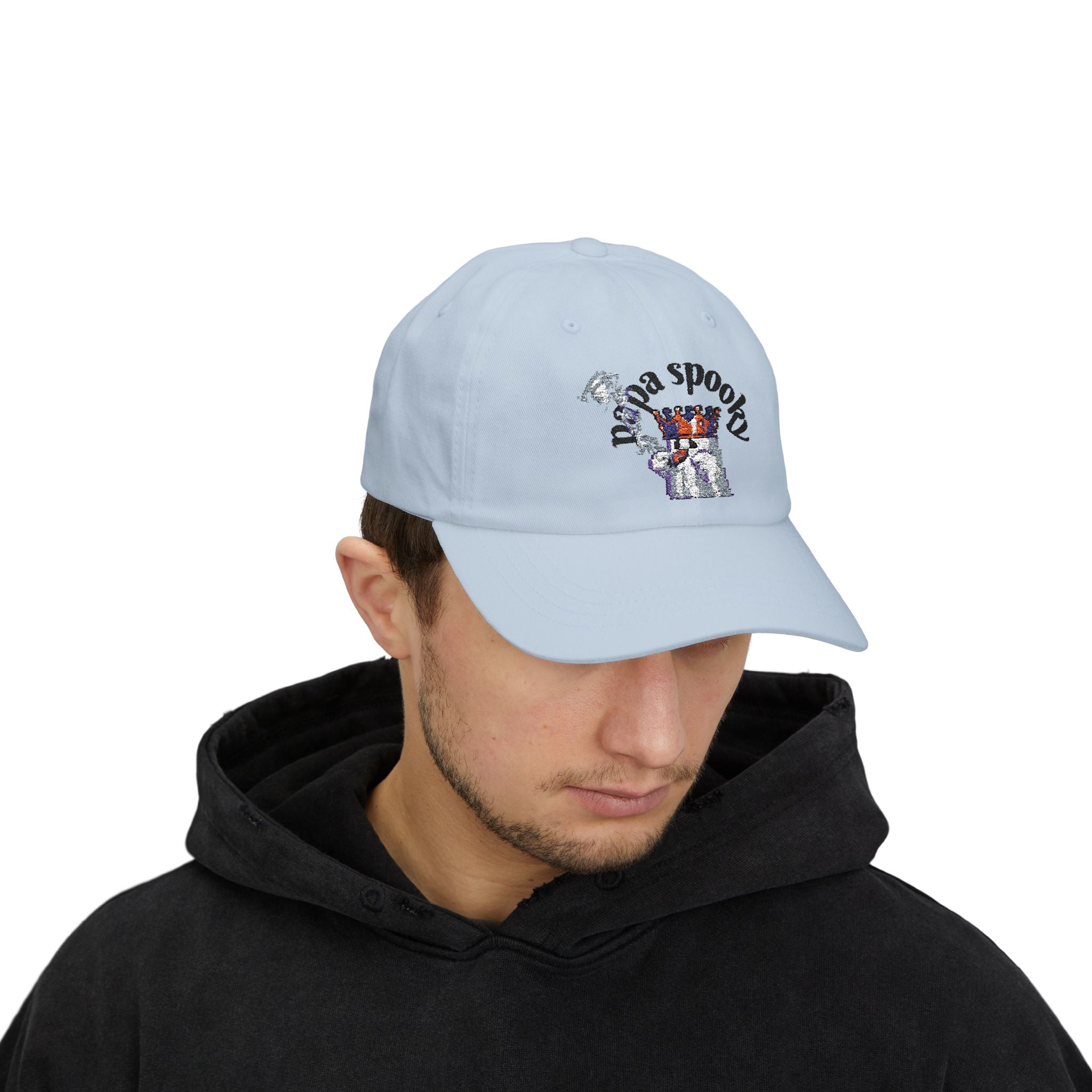 Person wearing a light blue cap with an embroidered design on a white background
