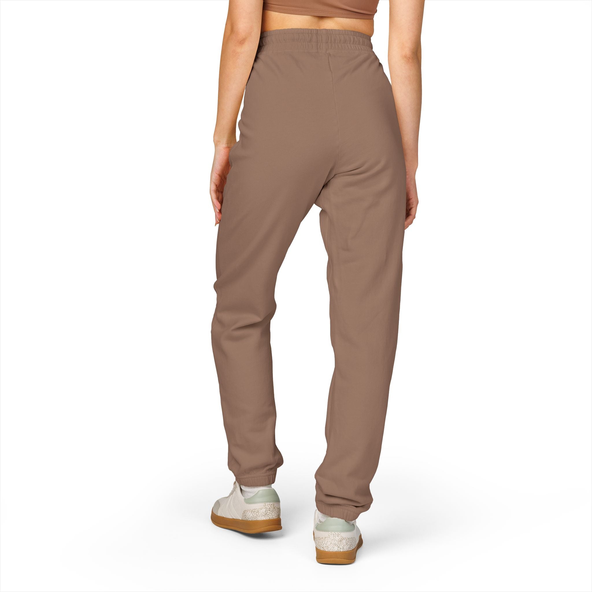 Brown pants worn by a person on a white background