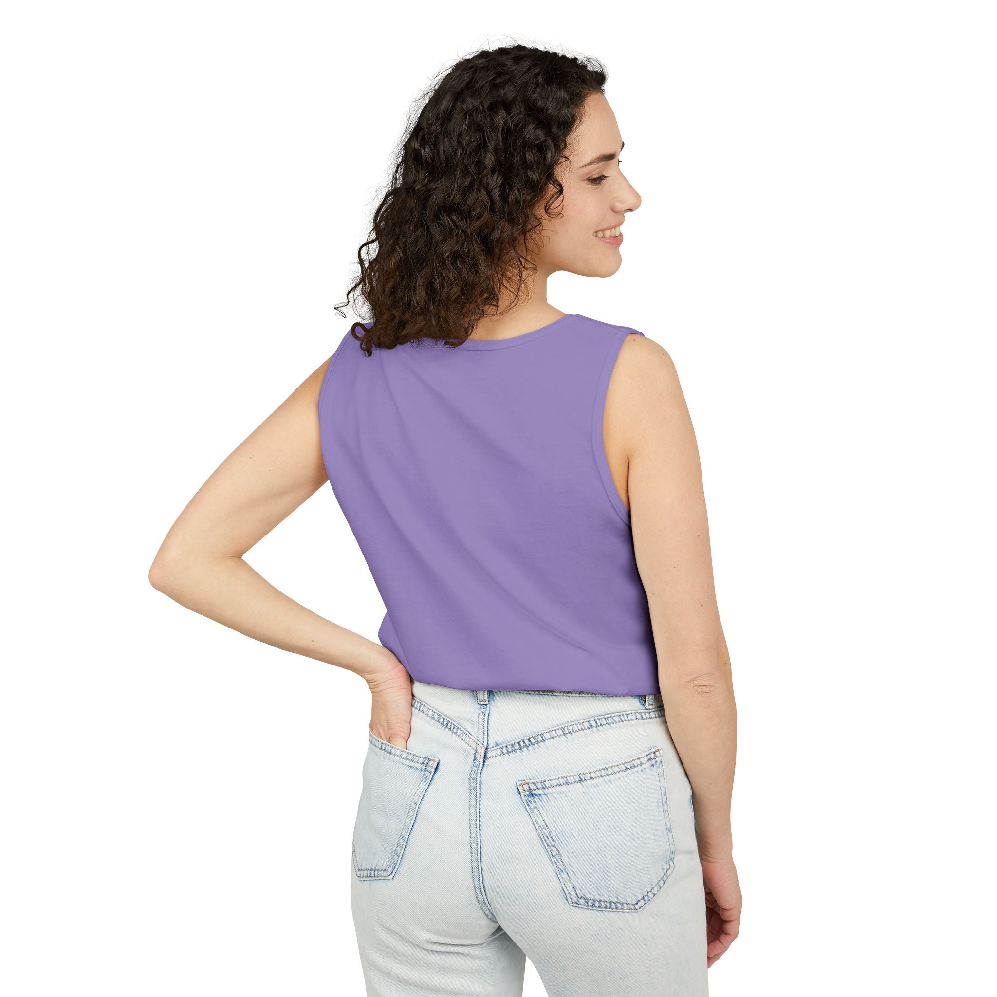 Woman wearing a purple sleeveless top and light blue jeans on a white background