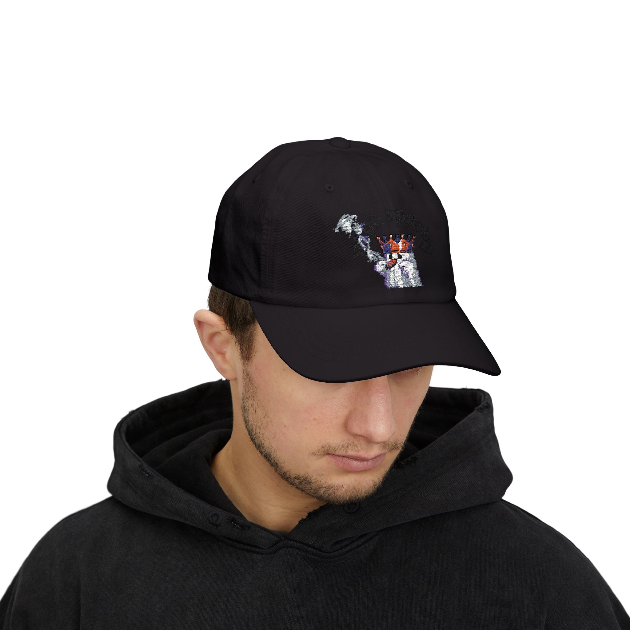 Person wearing a black cap with a robot design on a white background