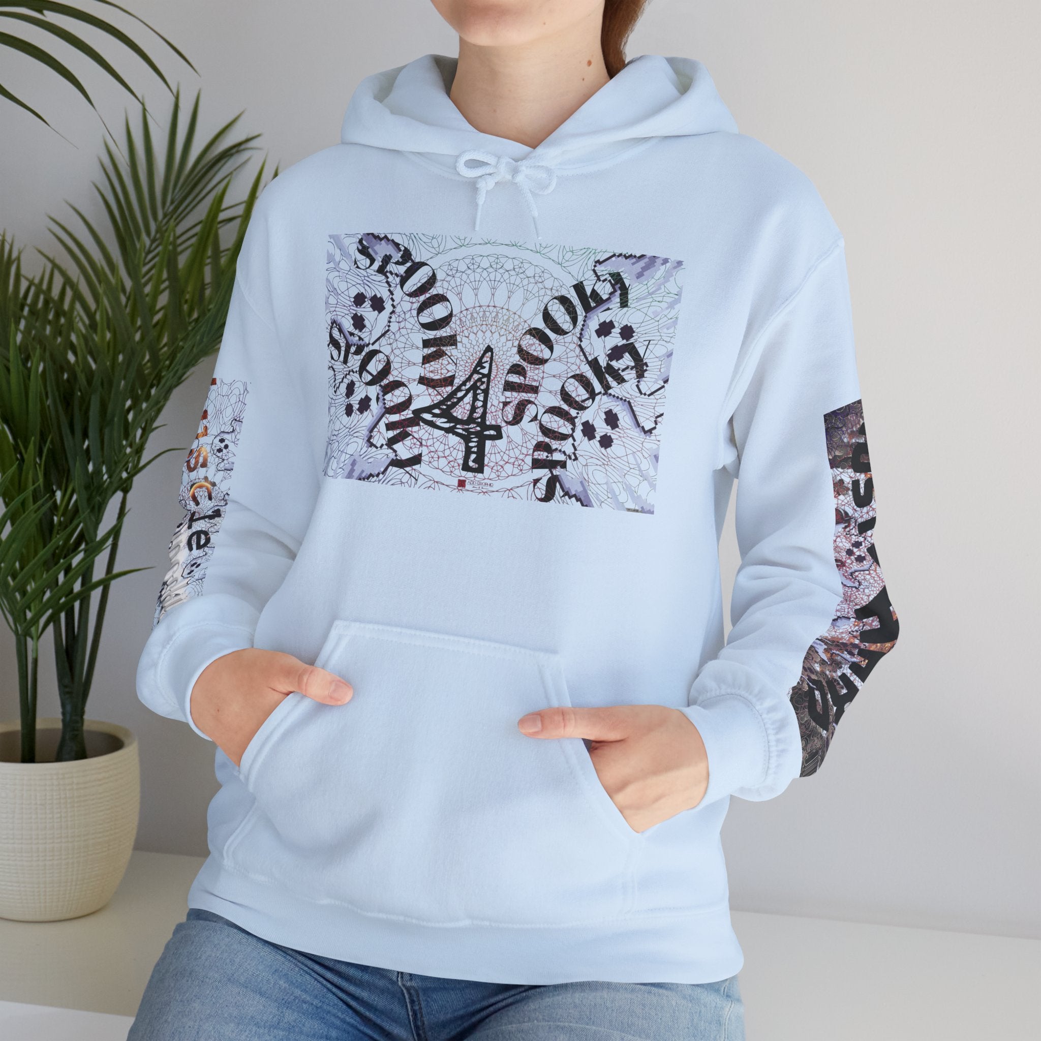 Light blue hoodie with decorative sleeves worn by a person, plant in the background