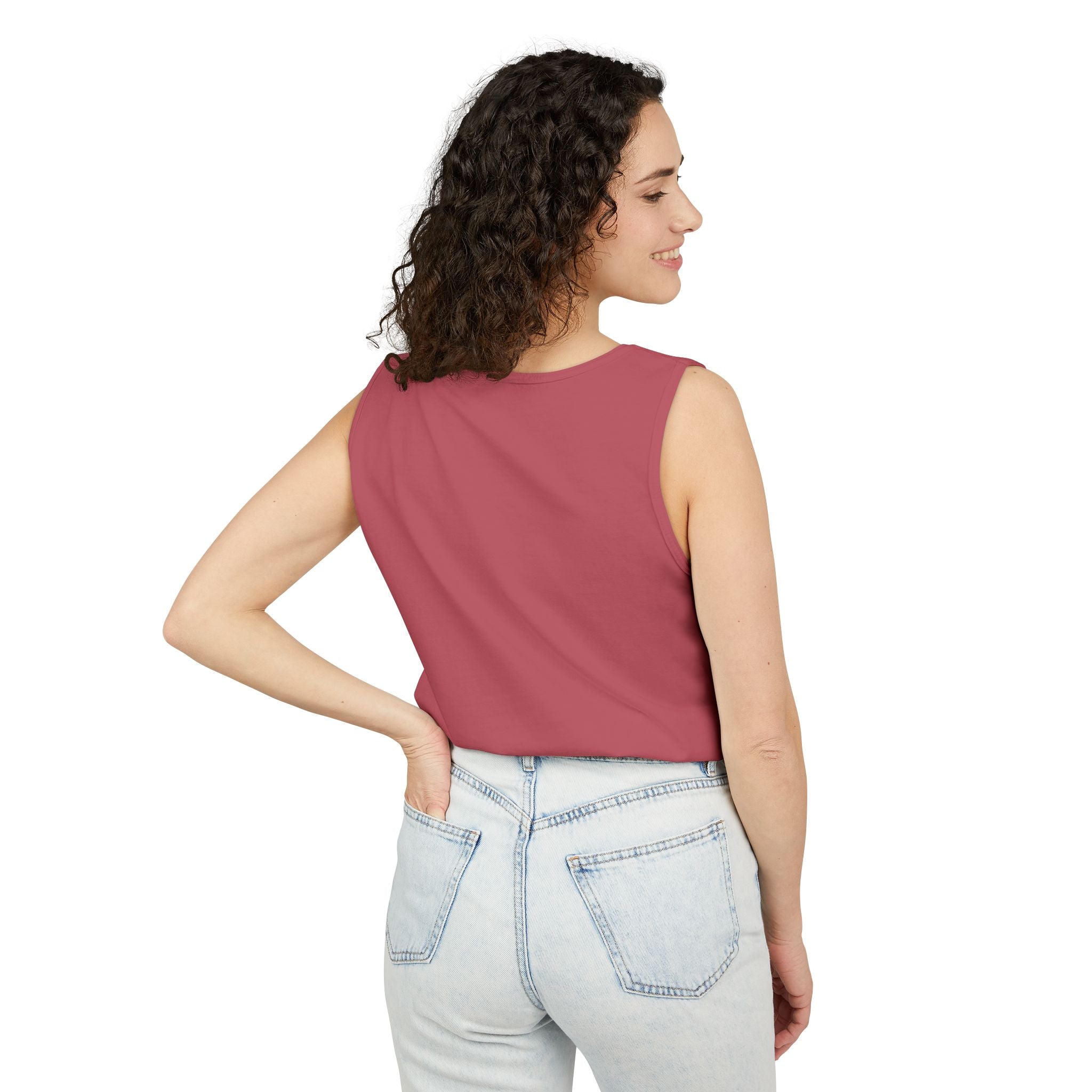 Woman wearing a sleeveless top and jeans on a white background
