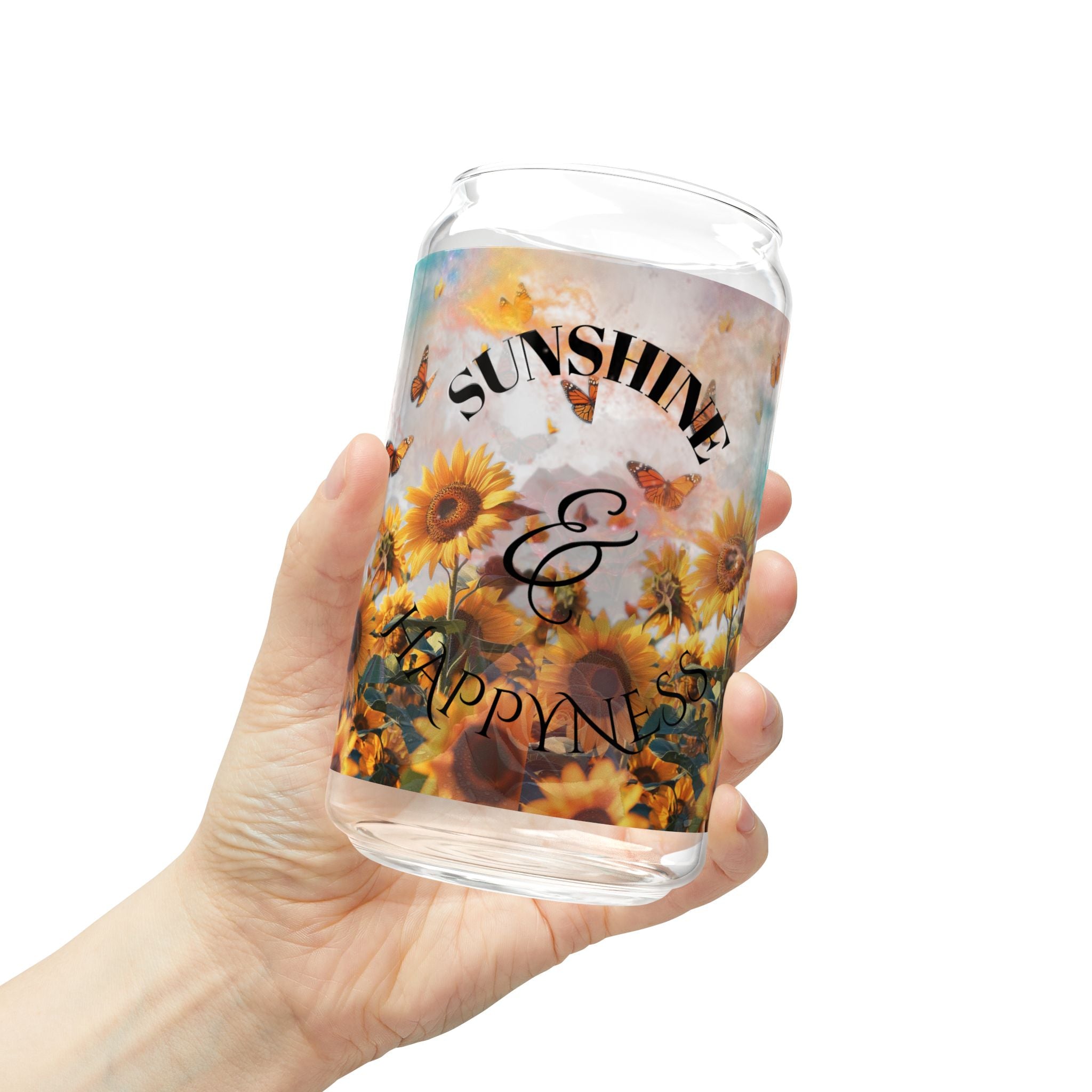 Hand holding a glass tumbler with sunflower design and 'Sunshine & Happiness' text.